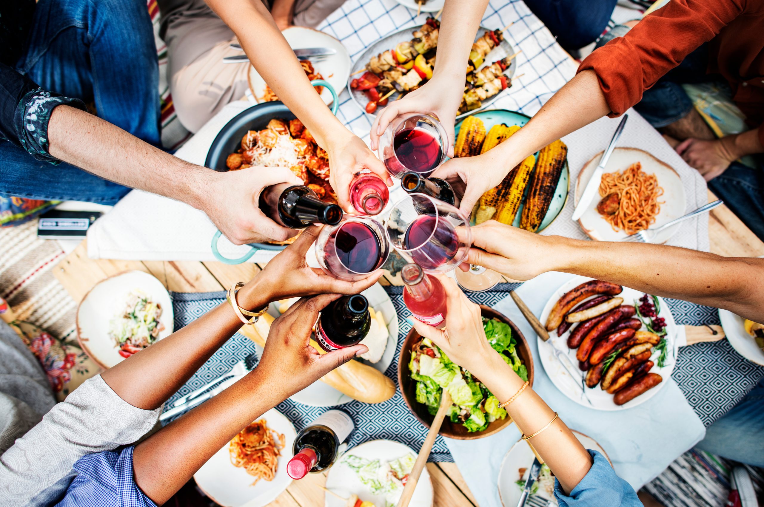 A group of friends celebrating over drinks and snacks to show Vortex SAP food and beverage experience.